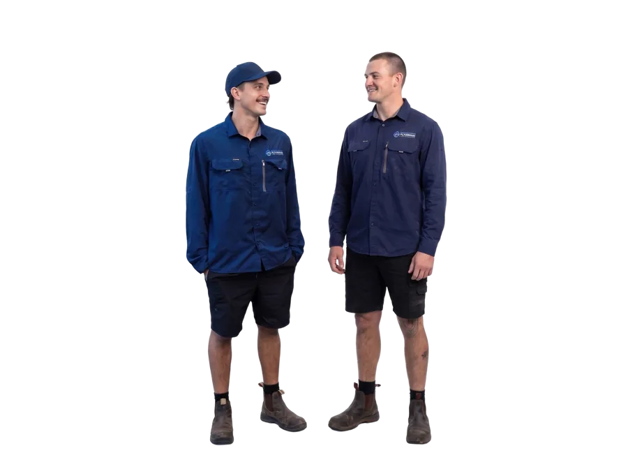 Two plumbers in navy work shirts and shorts sharing a laugh